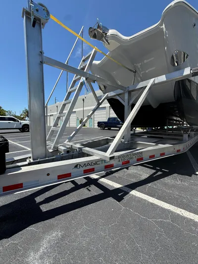  Yacht Photos Pics 2023 World Cat 325 CC boat on trailer in parking lot, sunny day.