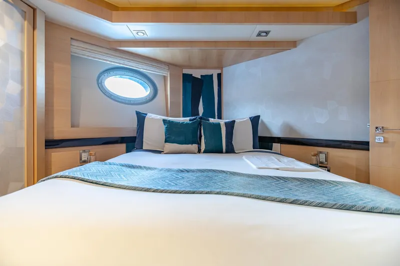  Yacht Photos Pics Luxurious bedroom interior of 2009 Palmer Johnson 120's KJOS yacht with porthole window.