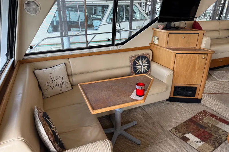  Yacht Photos Pics Interior of 1999 Bayliner 3988 Command Bridge Motoryacht with cozy seating and decorative pillows.