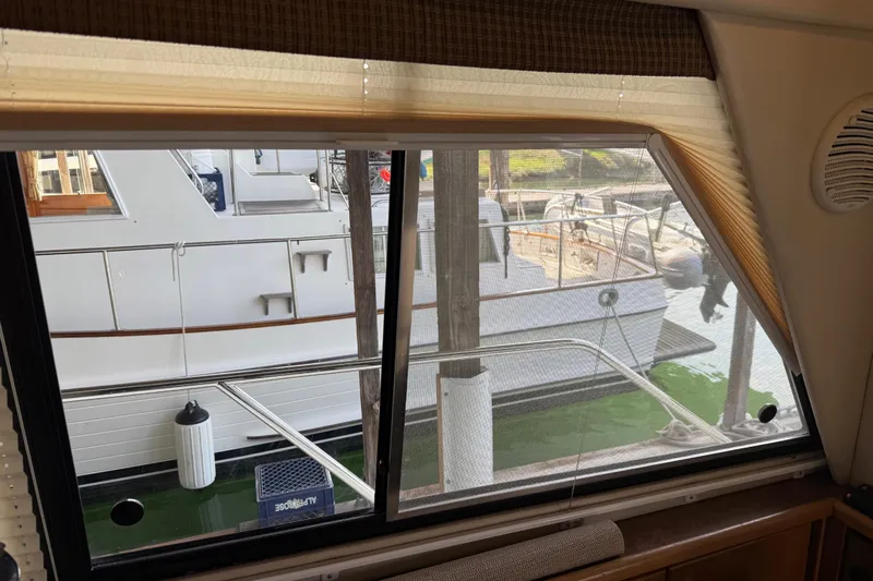  Yacht Photos Pics View from inside a 1999 Bayliner 3988 Command Bridge Motoryacht, showing docked boats outside.