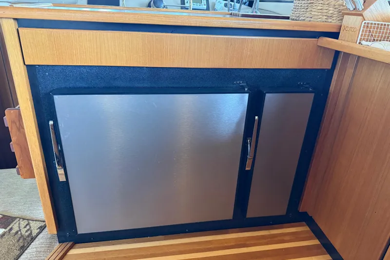  Yacht Photos Pics Stainless steel refrigerator on 1999 Bayliner 3988 Command Bridge Motoryacht, wooden cabinetry.