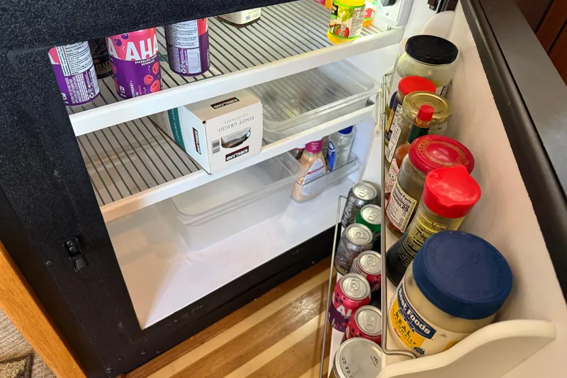  Yacht Photos Pics Open fridge on 1999 Bayliner 3988 yacht, stocked with drinks and condiments.