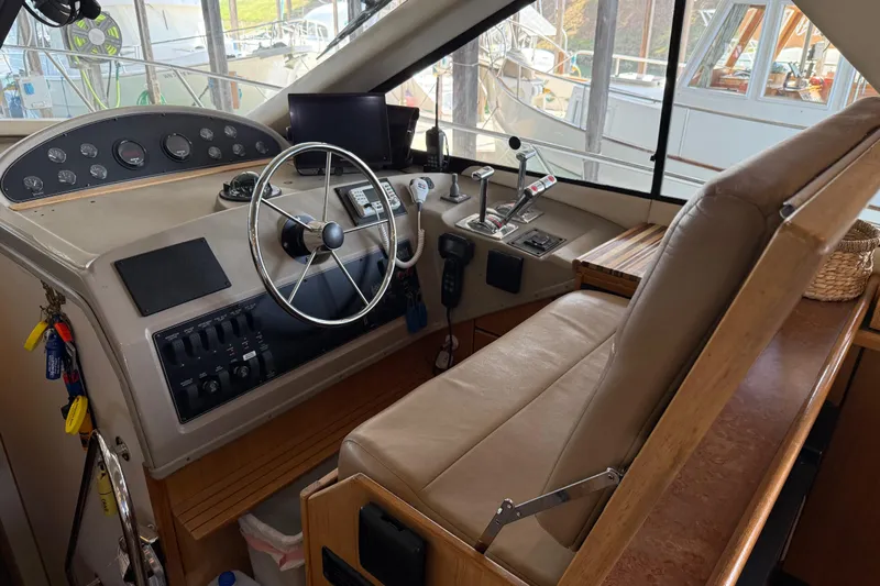  Yacht Photos Pics 1999 Bayliner 3988 Command Bridge Motoryacht helm with steering wheel and control panel.