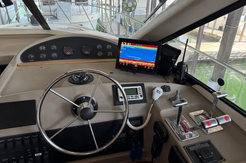  Yacht Photos Pics 1999 Bayliner 3988 Command Bridge Motoryacht helm with steering wheel and navigation equipment.