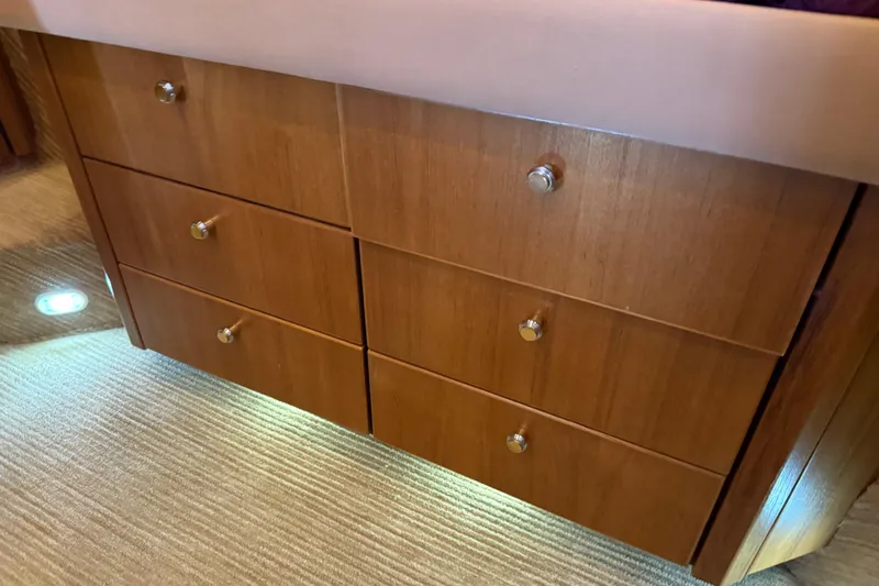  Yacht Photos Pics Wooden drawers inside 1999 Bayliner 3988 Command Bridge Motoryacht, featuring sleek design and metallic knobs.