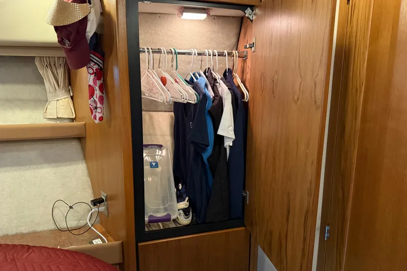  Yacht Photos Pics Closet interior on 1999 Bayliner 3988 Command Bridge Motoryacht with hanging clothes and accessories.