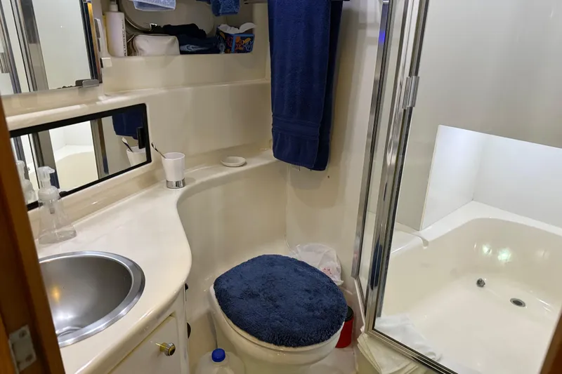  Yacht Photos Pics Bathroom interior of 1999 Bayliner 3988 Command Bridge Motoryacht, featuring sink and shower.