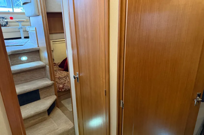  Yacht Photos Pics Interior of 1999 Bayliner 3988 Command Bridge Motoryacht with wooden doors and carpeted stairs.