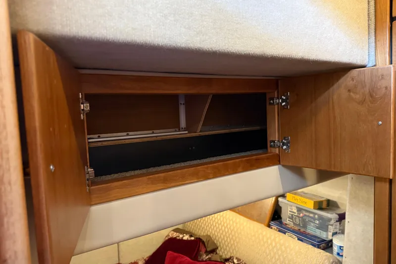  Yacht Photos Pics 1999 Bayliner 3988 Command Bridge Motoryacht interior storage compartment with open wooden cabinet.