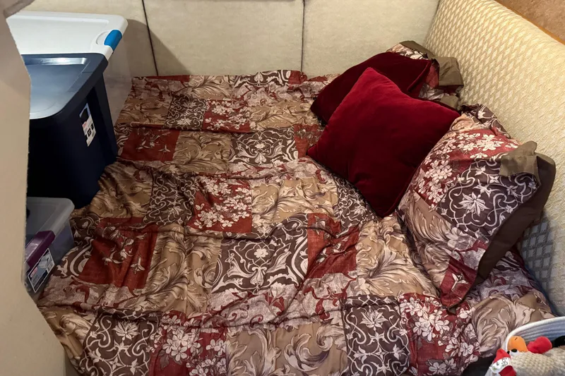  Yacht Photos Pics Cozy cabin interior of 1999 Bayliner 3988 Command Bridge Motoryacht with patterned bedding.