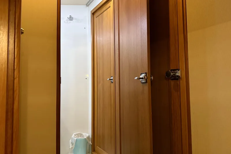  Yacht Photos Pics Interior of 1999 Bayliner 3988 Command Bridge Motoryacht with wooden doors and trash bin.