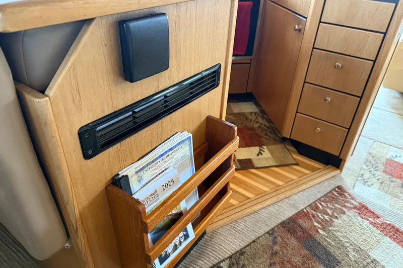  Yacht Photos Pics Interior of 1999 Bayliner 3988 Command Bridge Motoryacht with wooden cabinetry and magazine holder.