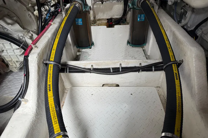  Yacht Photos Pics Engine compartment of 1999 Bayliner 3988 Command Bridge Motoryacht with exhaust hoses and components.