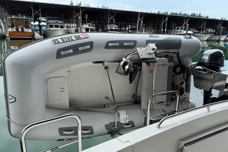  Yacht Photos Pics 1999 Bayliner 3988 Command Bridge Motoryacht with inflatable dinghy and outboard motor at marina.