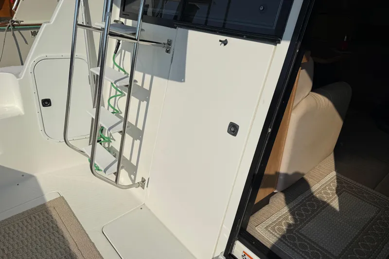  Yacht Photos Pics 1999 Bayliner 3988 Command Bridge Motoryacht interior with ladder and seating area.