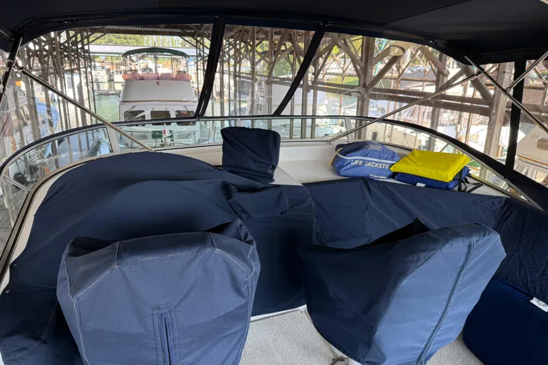  Yacht Photos Pics 1999 Bayliner 3988 Command Bridge Motoryacht interior with covered seating and life jackets.