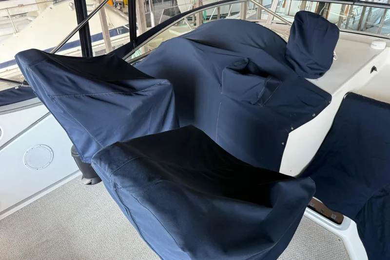  Yacht Photos Pics 1999 Bayliner 3988 Command Bridge Motoryacht helm covered with navy blue protective fabric.