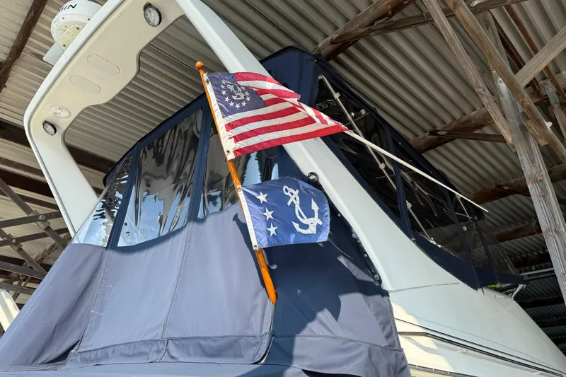  Yacht Photos Pics 1999 Bayliner 3988 Command Bridge Motoryacht with American and nautical flags displayed.