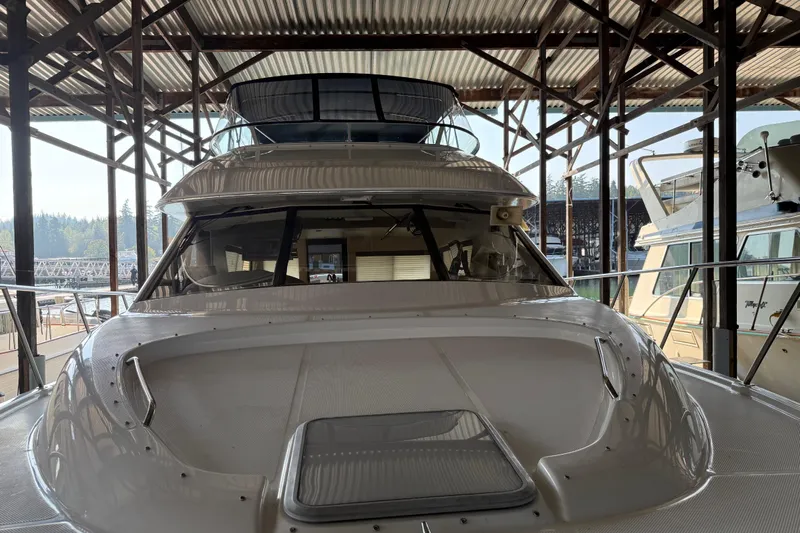  Yacht Photos Pics 1999 Bayliner 3988 Command Bridge Motoryacht docked in a covered marina.