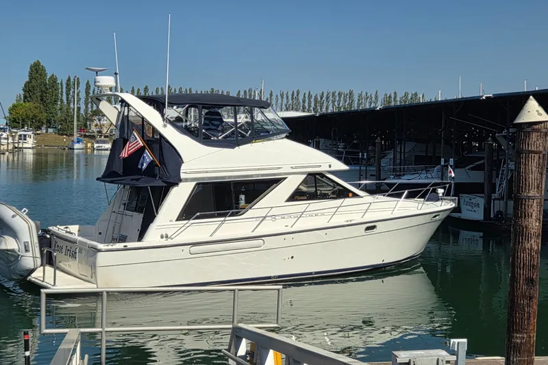  Yacht Photos Pics 1999 Bayliner 3988 Command Bridge Motoryacht docked in a marina under clear skies.