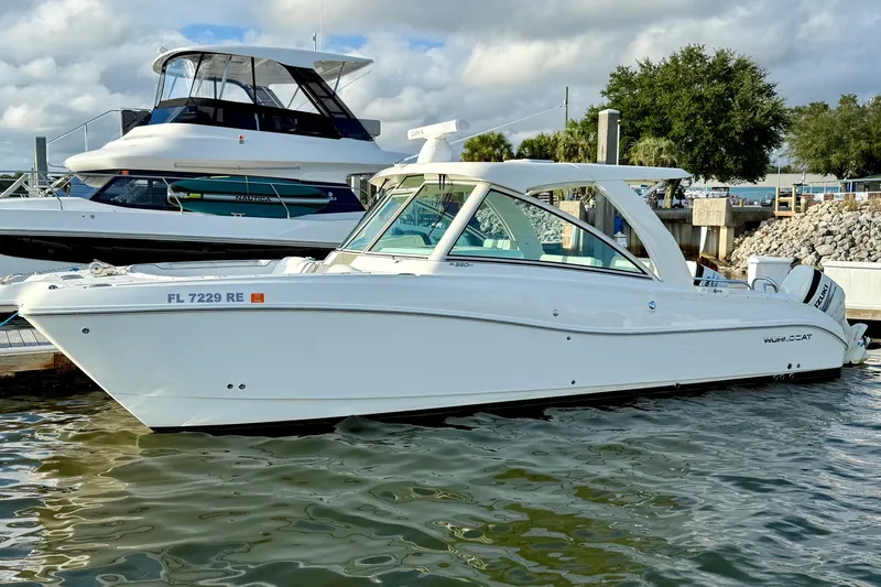  Yacht Photos Pics 2016 World Cat 320 DC boat docked at marina under cloudy sky.