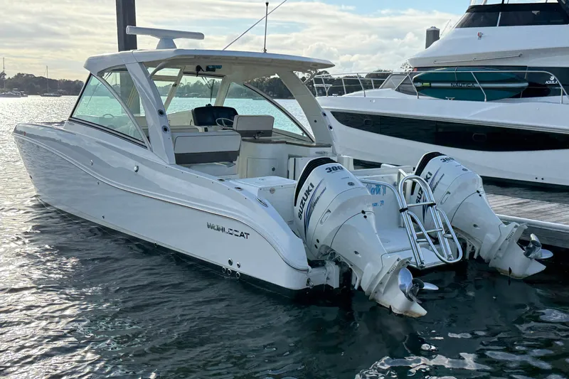  Yacht Photos Pics 2016 World Cat 320 DC boat with twin Suzuki 300 engines docked in marina.