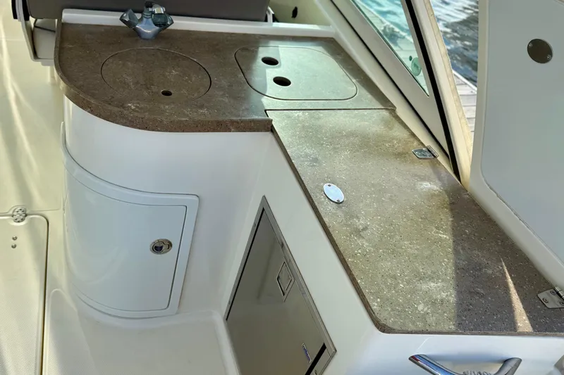  Yacht Photos Pics 2016 World Cat 320 DC boat interior with sleek countertop and storage compartments.