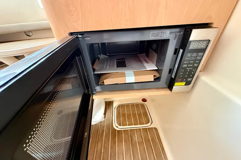  Yacht Photos Pics Microwave inside 2016 World Cat 320 DC boat with wooden flooring.