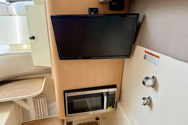  Yacht Photos Pics 2016 World Cat 320 DC interior with TV and microwave setup.