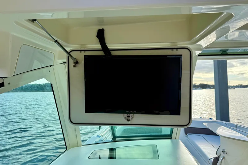 Yacht Photos Pics 2016 World Cat 320 DC boat interior with mounted TV and scenic water view.