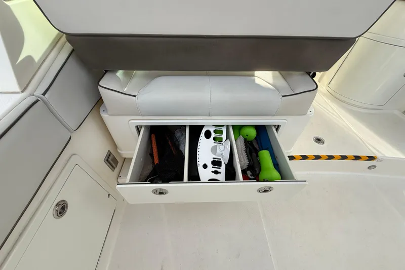  Yacht Photos Pics Storage drawer on 2016 World Cat 320 DC boat, containing various boating accessories.