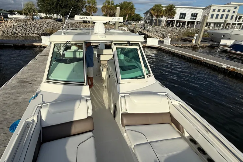  Yacht Photos Pics 2016 World Cat 320 DC boat docked, featuring spacious seating and Garmin equipment.