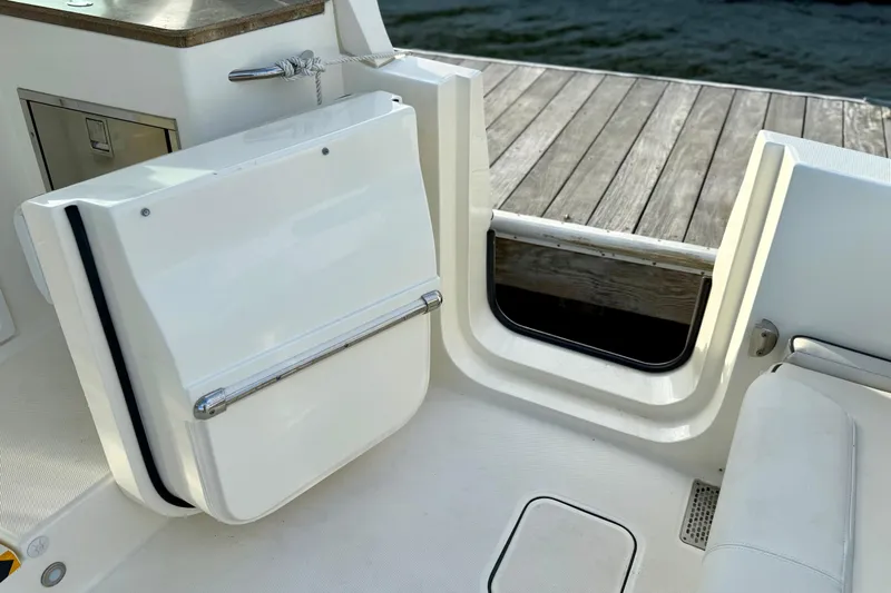  Yacht Photos Pics 2016 World Cat 320 DC boat interior with open transom door and seating area.