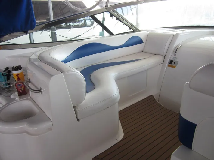  Yacht Photos Pics 2000 Cruisers Yachts 4270 Express interior with white and blue seating, wooden flooring.