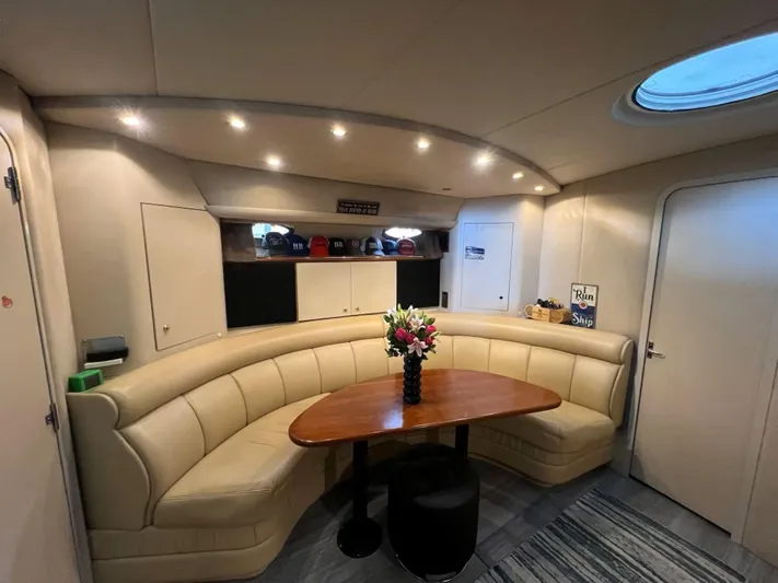  Yacht Photos Pics Luxurious interior of 2000 Cruisers Yachts 4270 Express with elegant seating and table.
