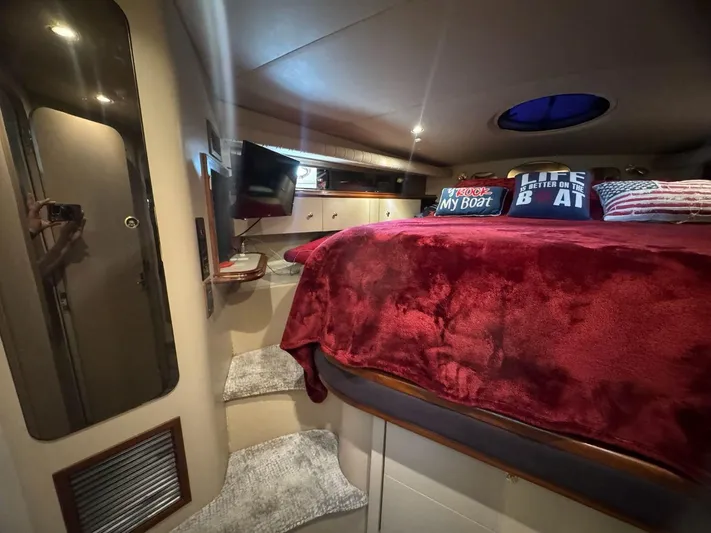  Yacht Photos Pics Luxurious cabin interior of 2000 Cruisers Yachts 4270 Express with plush bedding and cozy decor.