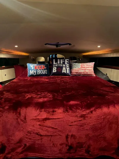  Yacht Photos Pics Luxurious cabin interior of 2000 Cruisers Yachts 4270 Express with plush bedding and decorative pillows.
