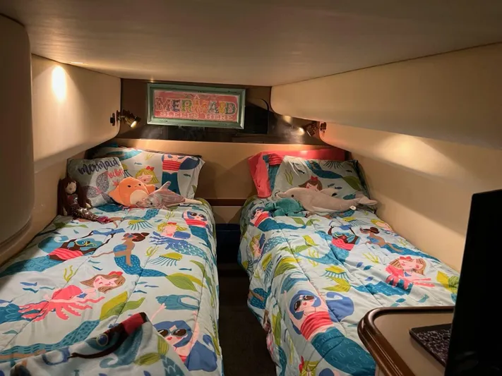  Yacht Photos Pics Twin beds with colorful mermaid-themed bedding in a 2000 Cruisers Yachts 4270 Express cabin.