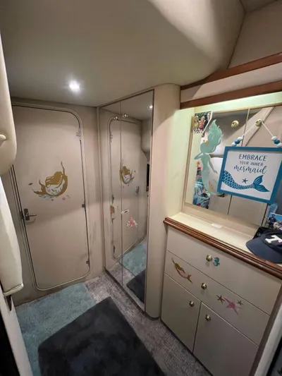  Yacht Photos Pics Interior of 2000 Cruisers Yachts 4270 Express with mermaid-themed decor and mirrored closet.