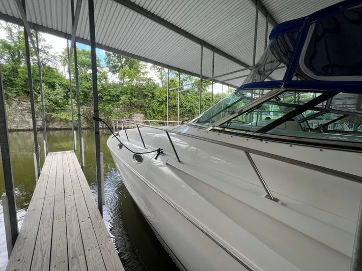  Yacht Photos Pics 2000 Cruisers Yachts 4270 Express docked under a covered marina.