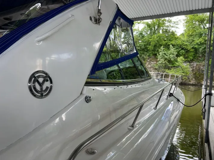  Yacht Photos Pics 2000 Cruisers Yachts 4270 Express docked, featuring sleek design and blue accents.