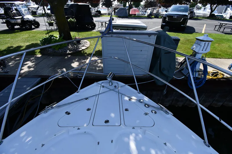  Yacht Photos Pics Bow view of 2003 Regal Commodore 3880 docked at marina with parked vehicles nearby.