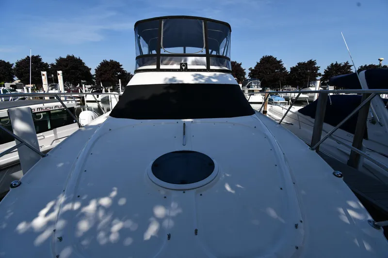  Yacht Photos Pics 2003 Regal Commodore 3880 yacht docked at marina under clear blue sky.