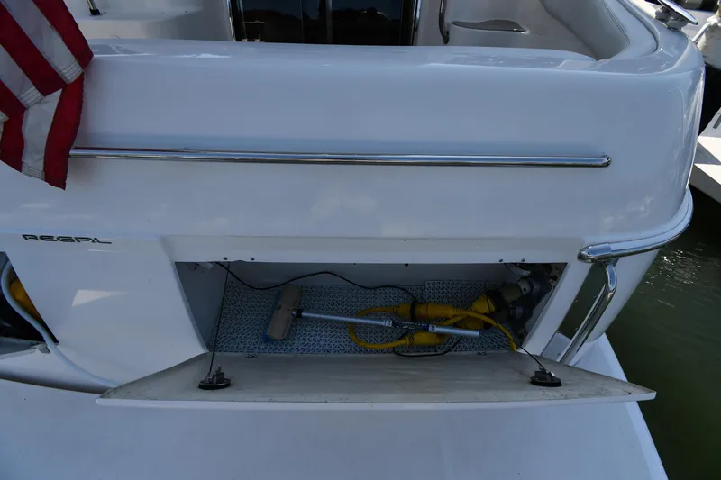  Yacht Photos Pics 2003 Regal Commodore 3880 boat storage compartment with American flag and equipment.