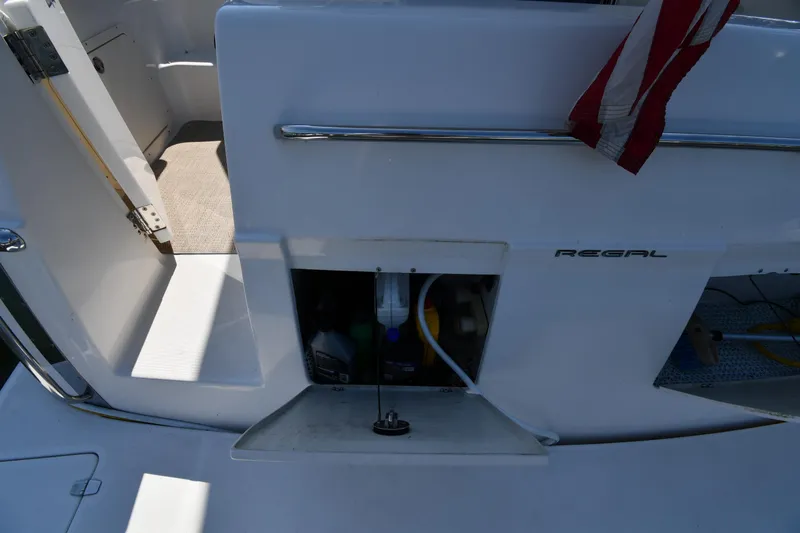  Yacht Photos Pics 2003 Regal Commodore 3880 boat interior with open storage compartment and American flag.