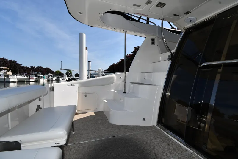  Yacht Photos Pics 2003 Regal Commodore 3880 yacht interior with seating and steps, docked at marina.