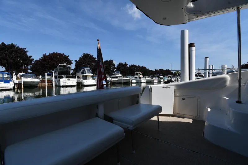  Yacht Photos Pics 2003 Regal Commodore 3880 yacht docked at marina, surrounded by boats under clear blue sky.