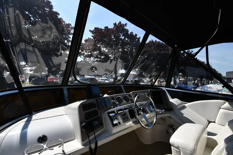  Yacht Photos Pics Interior view of 2003 Regal Commodore 3880 yacht cockpit with steering wheel and controls.