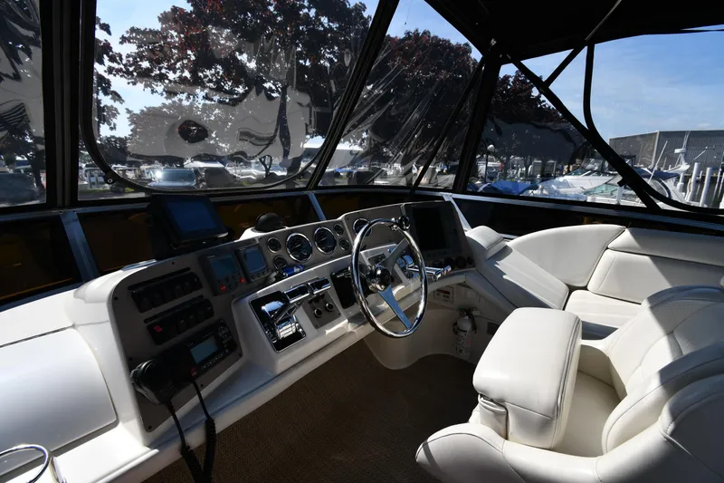  Yacht Photos Pics Interior of 2003 Regal Commodore 3880 yacht with modern helm and luxurious seating.