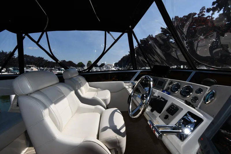  Yacht Photos Pics Interior of 2003 Regal Commodore 3880 yacht with white leather seats and control panel.